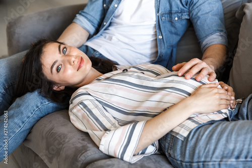 Attractive young pregnant couple relaxing