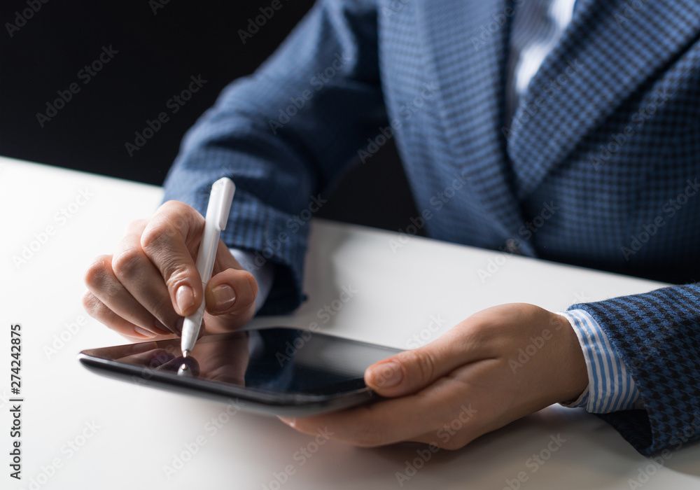 Man in business suit sitting at desk with tablet Man in business suit sitting at desk with tablet