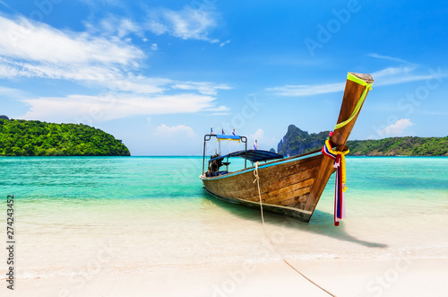 Thai traditional wooden longtail boat and beautiful sand beach. © preto_perola