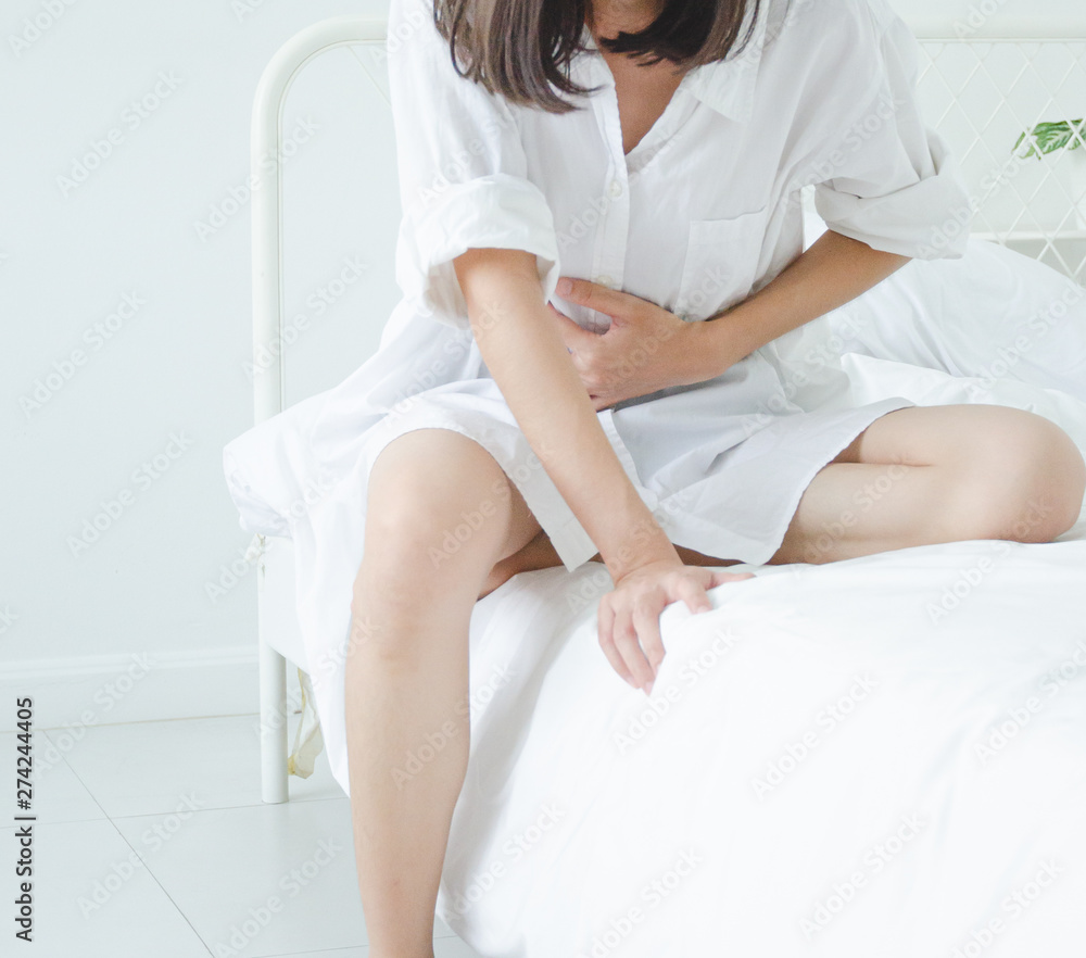 Asian girl has abdominal pain.When is menstruation.Catch his stomach.Women have bladder pain.Do not focus on objects Asian girl has abdominal pain.When is menstruation.Catch his stomach.Women have bladder pain.Do not focus on objects