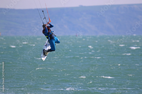 kitesurfer jumping with his board