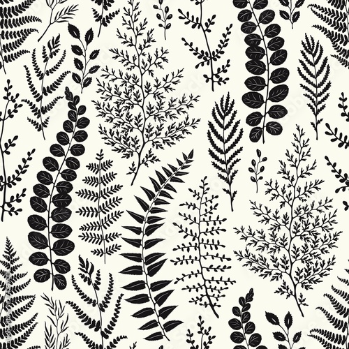 Seamless pattern of leaves and branches silhouettes, hand drawn vector illustration on beige background.