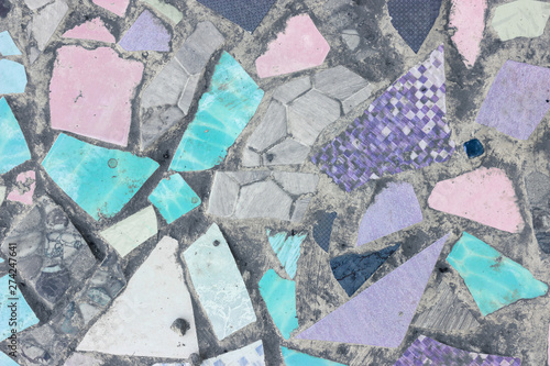 Colorful ceramic fragments and cement floor