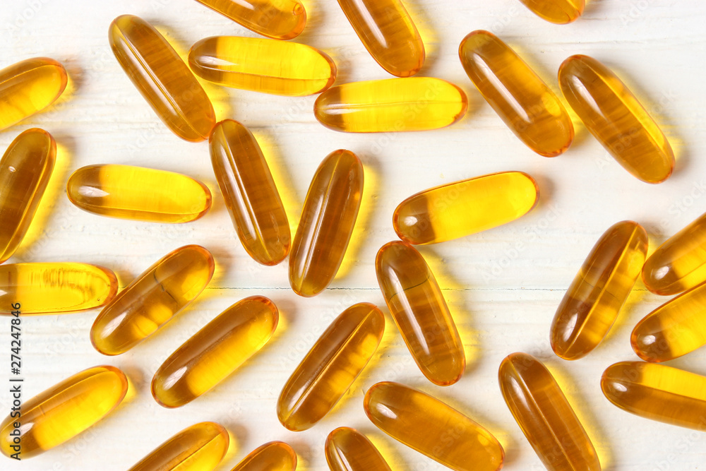 Omega-3 capsules on a colored background. Fish oil, healthy supplements
