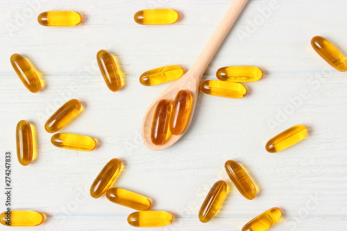 Omega-3 capsules on a colored background. Fish oil, healthy supplements