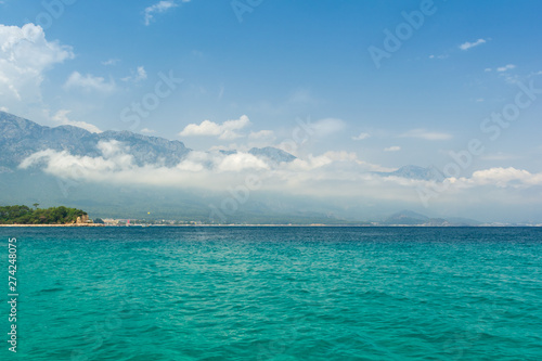 Sea view on Taurus Mountains covered by low clouds and Mediterranean sea from boat. Travel concept.