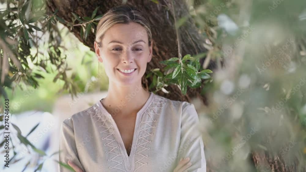 Natural beauty smiling outdoors amongst trees