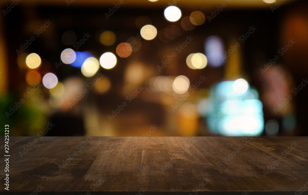 Empty dark wooden table in front of abstract blurred bokeh background of restaurant . can be used for display or montage your products.Mock up for space. Empty dark wooden table in front of abstract blurred bokeh background of restaurant . can be used for display or montage your products.Mock up for space.