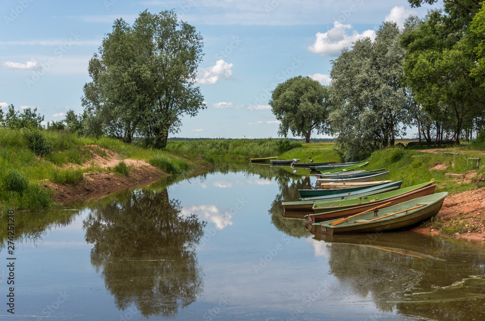 Fototapeta premium Small Fishing Boats on a Canal at a Lake in Latvia