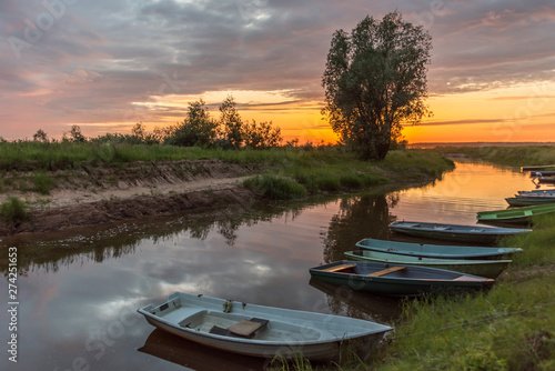 Small Fishing Boats on a Canal at a Lake in Latvia at Sunset
