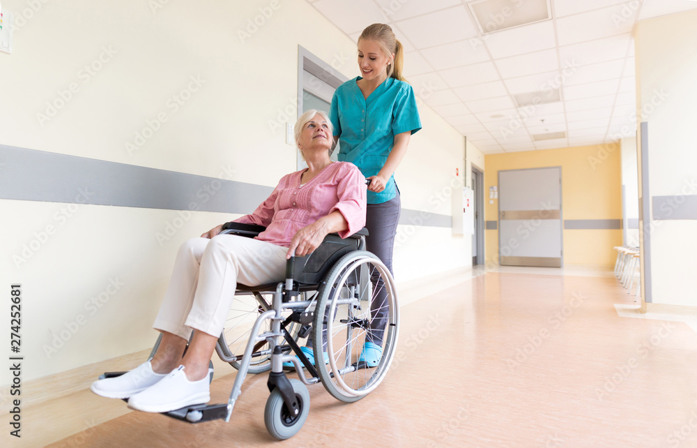 Senior woman in wheelchair with nurse in hospital Senior woman in wheelchair with nurse in hospital