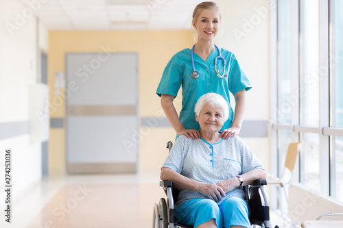 Senior woman in wheelchair with nurse in hospital © pikselstock