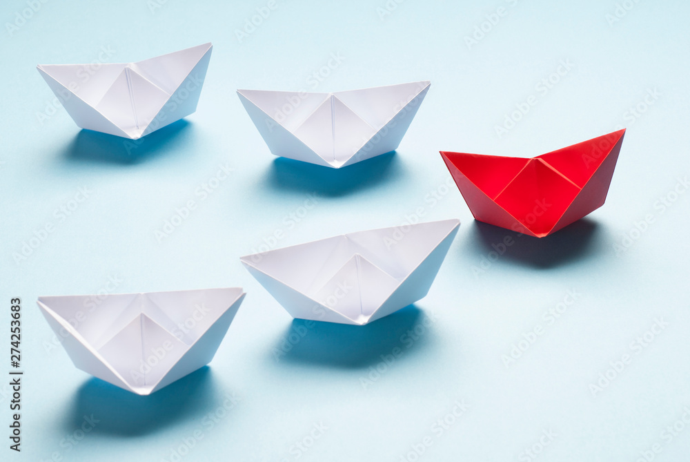Red and white origami boats on blue. Red and white origami boats on blue.