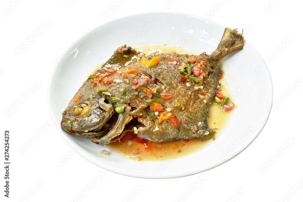 deep fried white pomfret dressing spicy sauce on plate deep fried white pomfret dressing spicy sauce on plate