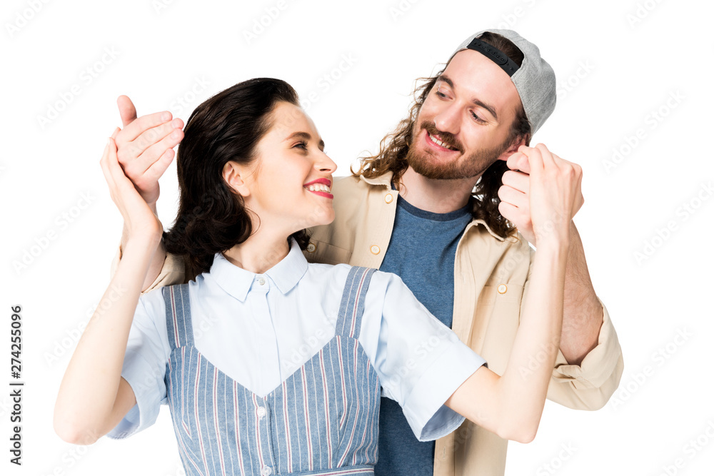 young couple smiling to each other and holding hands isolated on white young couple smiling to each other and holding hands isolated on white
