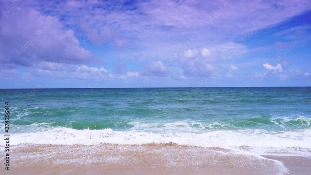 Beautiful beach with wave crashing on sandy shore and clear blue sky over sea Beautiful beach with wave crashing on sandy shore and clear blue sky over sea