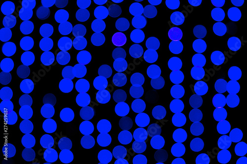 Unfocused abstract dark blue bokeh on black background. defocused and blurred many round light © sosiukin