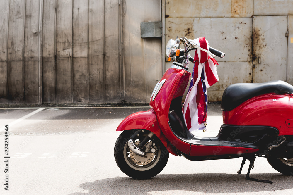red scooter with American flag on handle