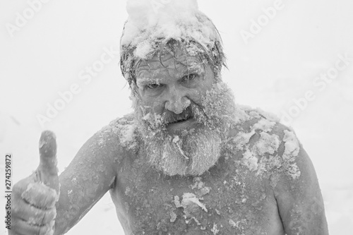 Bearded man, after bathing in the snow