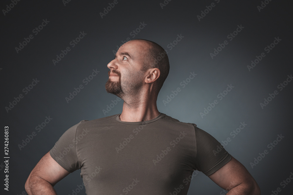 Fototapeta premium studio portrait of a man with a satisfied and proud expression, side view