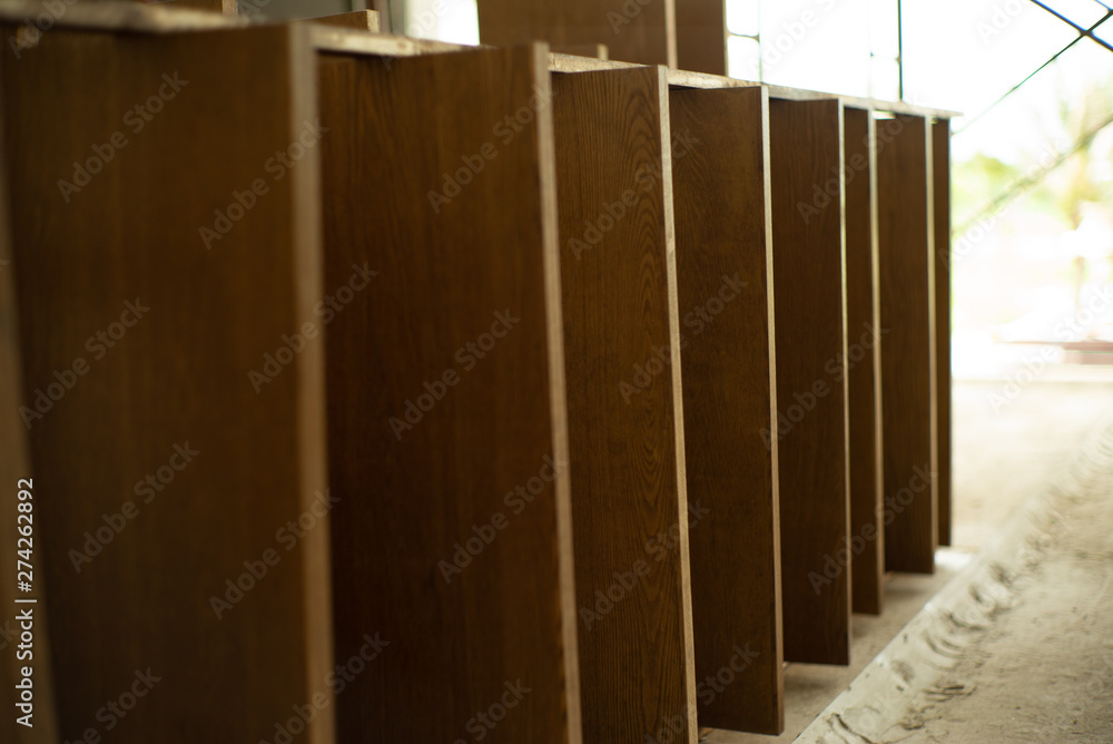 Selective focus on wooden laminated board at the factory waiting for installation.