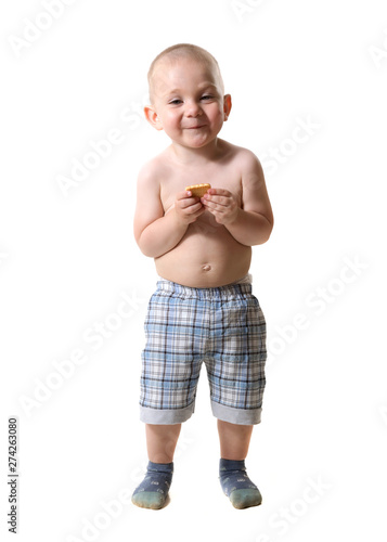 Portrait of a blond blue-eyed child in full growth, on a white background. In the hands of cookies.