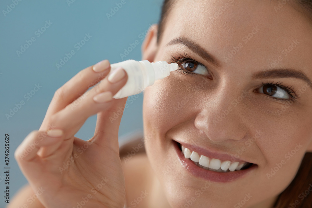 Eye drop. Woman applying lubricant eye drops in her eyes closeup Eye drop. Woman applying lubricant eye drops in her eyes closeup