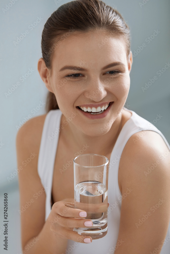 Drink water. Smiling woman holding fresh pure water in glass Drink water. Smiling woman holding fresh pure water in glass