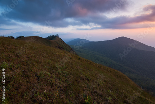 beautiful sunset on the mountain with green field at doi monjong