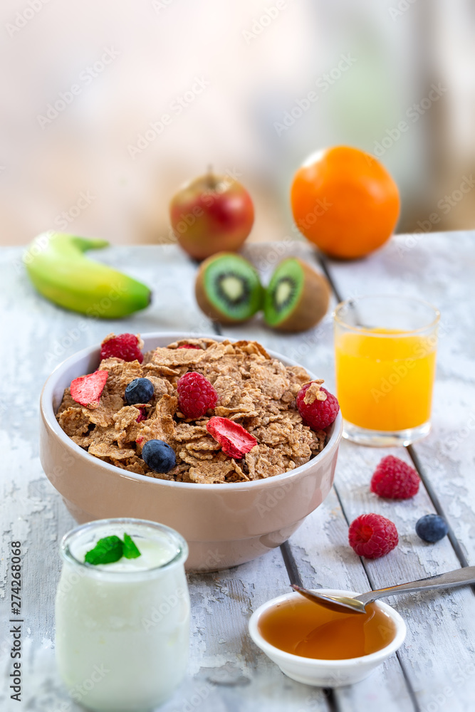 Healthy breakfast with bowl of cereal, orange juice, milk, , and fruits on white background. Healthy breakfast with bowl of cereal, orange juice, milk, , and fruits on white background.