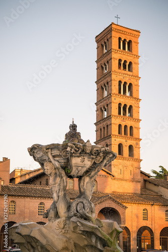 Basilica of  S. Maria in Cosmedin bell tower and detail of the Tritons fountain, Rome, Italy. photo