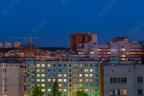 Windows, roofs and facade of an mass apartment buildings in Russia photo