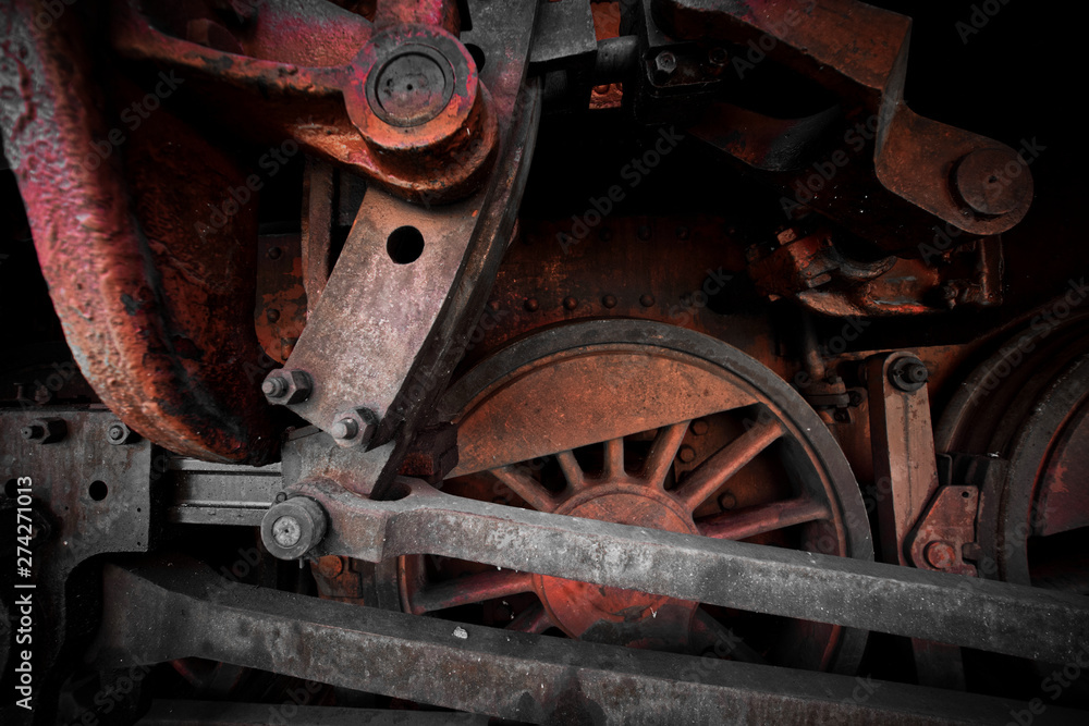 Close-up of the drive wheels and the drive rod of a historic steam locomotive