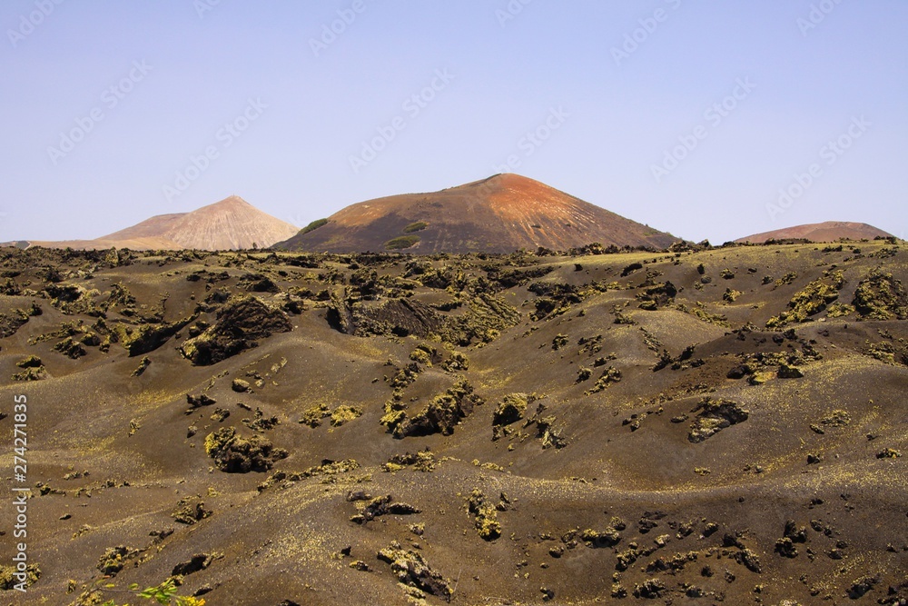 View over black lava field on cone of volcano - Timanfaya NP Lanzarote