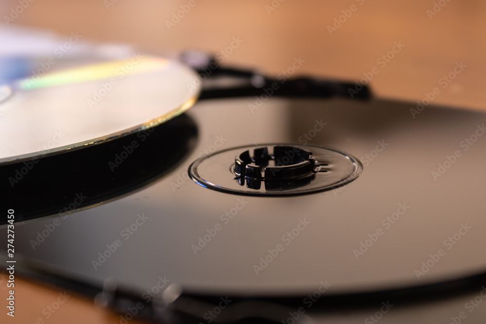 Black plastic CD DVD disc box with CD disc near it - Image Black plastic CD DVD disc box with CD disc near it - Image