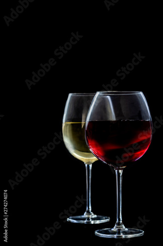 two glasses of red an withe Wine on black backgroundcopy space photo