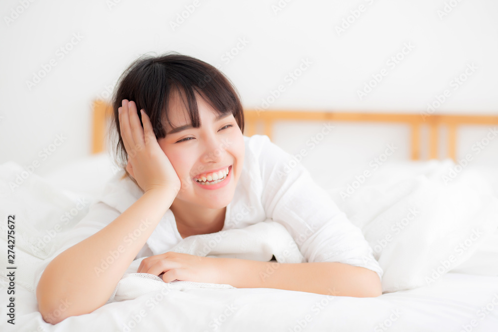 Beautiful portrait young asian woman lying and smile while wake up with sunrise at morning, lifestyle and relax concept. Beautiful portrait young asian woman lying and smile while wake up with sunrise at morning, lifestyle and relax concept.