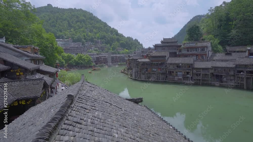 Views from Fenghuang bridge to main river. Picturesque view of boats sailing on river Views from Fenghuang bridge to main river. Picturesque view of boats sailing on river