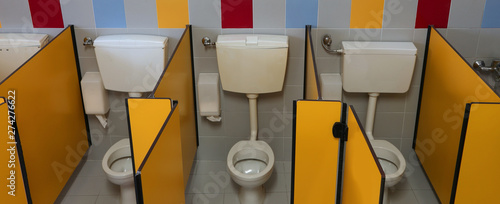 three small toilet in the bathroom of a preschool