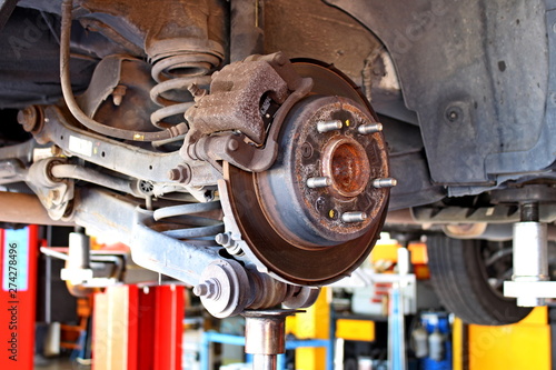 car disc brakes and visible shock absorbers without wheel