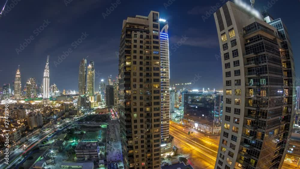 Beautiful skyline of Dubai downtown and Business bay with modern architecture night timelapse. Aerial view of Dubai illuminated skyscrapers from above with traffic on the road Beautiful skyline of Dubai downtown and Business bay with modern architecture night timelapse. Aerial view of Dubai illuminated skyscrapers from above with traffic on the road