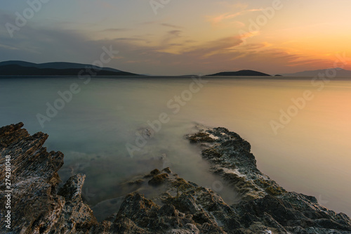Sunset seascape - Long exposure rock formations into the sea at sunset