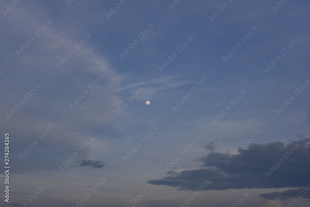 blue sky with clouds and the moon