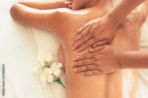 Masseuse or service provider shoulder massage with Young Asian woman while her enjoying Oil spa massage in spa salon at hotel or resort. Beauty lifestyle and people concept