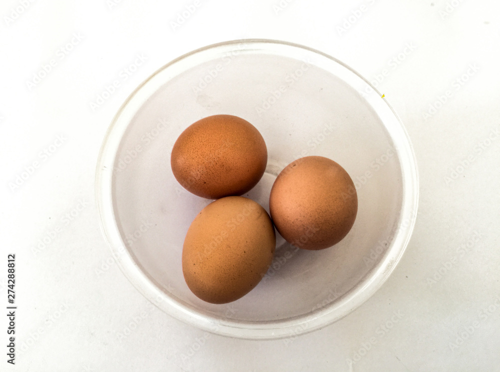 Eggs: brown eggs in separate cups on a white background in close-up shot from top to bottom Thailand Eggs: brown eggs in separate cups on a white background in close-up shot from top to bottom Thailand