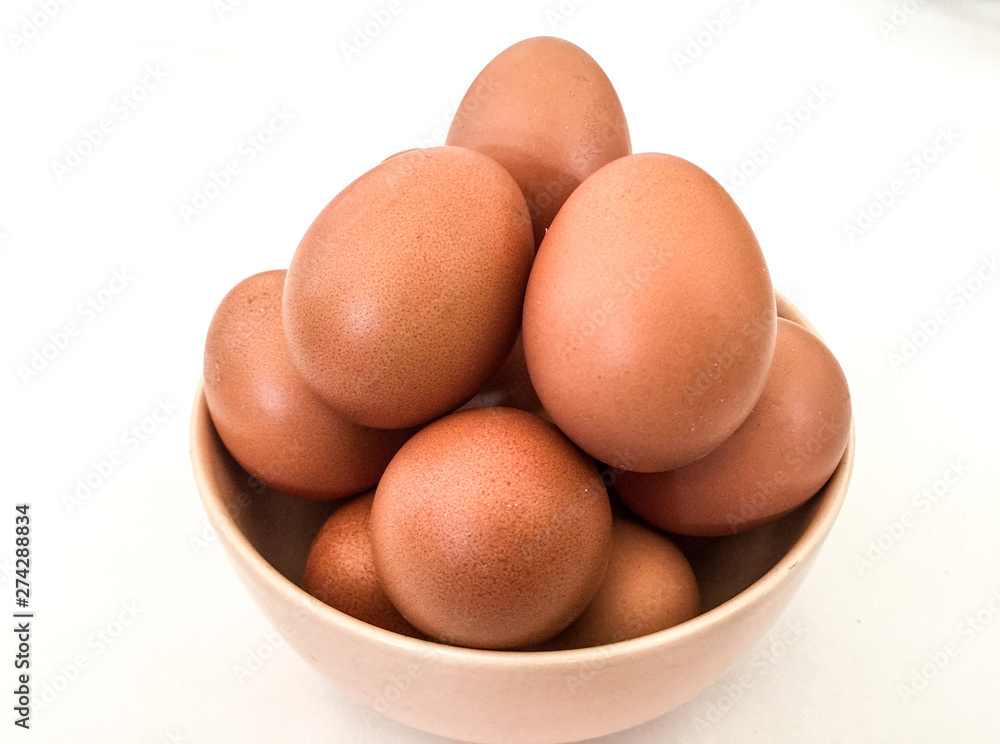 Eggs: brown eggs in separate cups on a white background in close-up shot from top to bottom Thailand Eggs: brown eggs in separate cups on a white background in close-up shot from top to bottom Thailand
