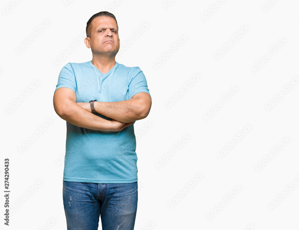 Middle age arab man wearing blue t-shirt over isolated background skeptic and nervous, disapproving expression on face with crossed arms. Negative person. Middle age arab man wearing blue t-shirt over isolated background skeptic and nervous, disapproving expression on face with crossed arms. Negative person.