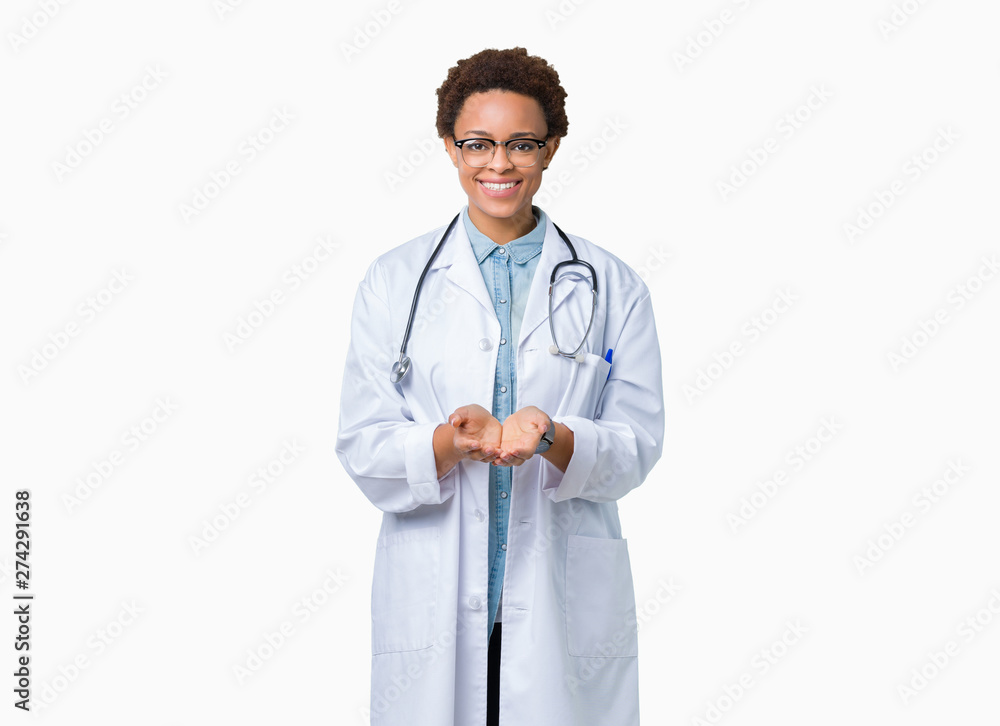 Fototapeta premium Young african american doctor woman wearing medical coat over isolated background Smiling with hands palms together receiving or giving gesture. Hold and protection