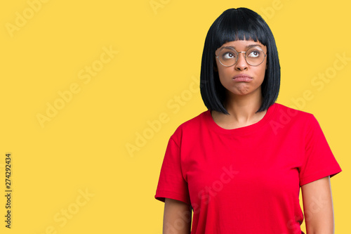 Beautiful young african american woman wearing glasses over isolated background depressed and worry for distress, crying angry and afraid. Sad expression. © Krakenimages.com