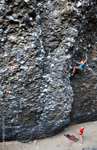 Climbers at the crux on the Roache (5.11a) at Deep Creek.